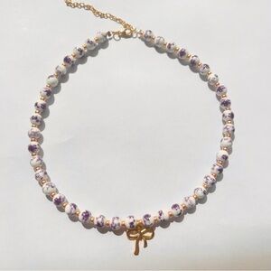 Gold bow necklace with floral ceramic beads golden bow tie charm necklace